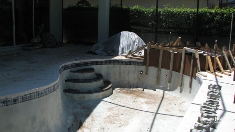 Damaged pool tile ready for repair, showing cracks and wear.